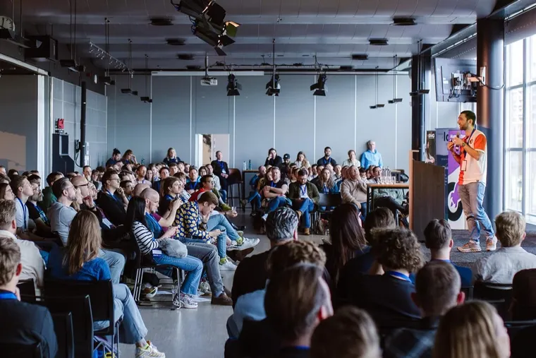 Alex Moss speaking on stage